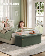 SONGMICS Colección Mazie - Banco otomano plegable de almacenamiento de 43 pulgadas, otomano con almacenamiento, taburete reposapiés, carga 660 lb, para sala de estar, piel sintética, verde bosque