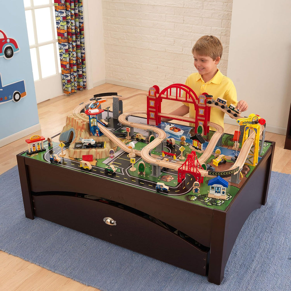 KidKraft Metropolis - Juego de tren de madera y mesa con 100 piezas y cajón de almacenamiento, color espresso